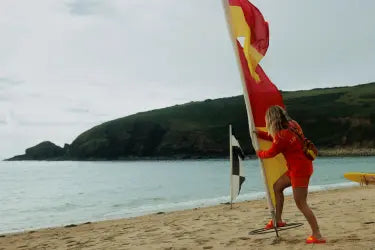 RNLI lifeguard standing near the shore